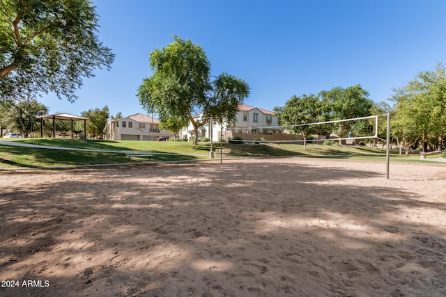 surrounding community with a gazebo, volleyball court, and a lawn