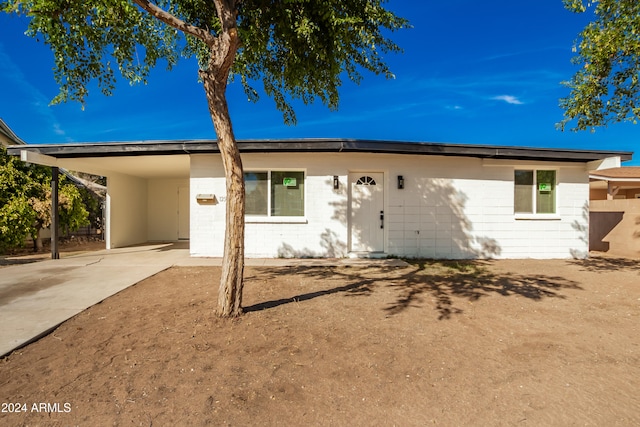 back of house with a carport