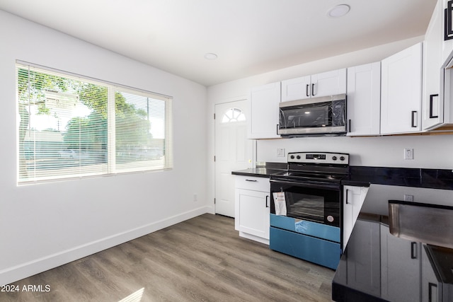 kitchen featuring white cabinetry, stainless steel appliances, and hardwood / wood-style flooring