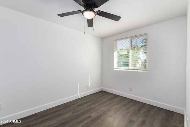 spare room featuring dark wood-type flooring and ceiling fan