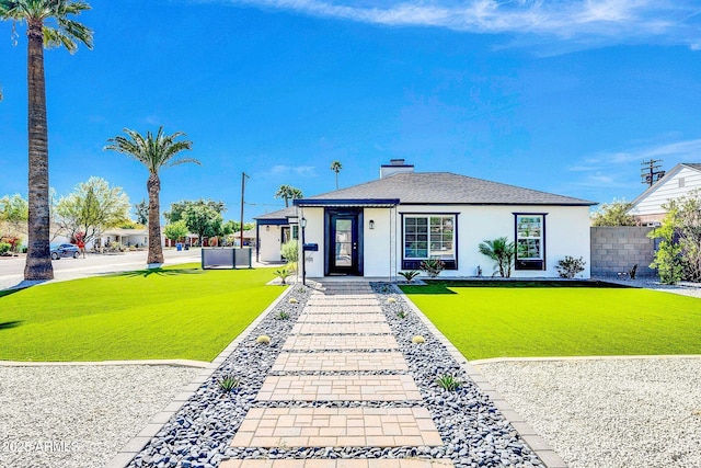2926 N 16th Ave, Phoenix, AZ 85015 - view of front of home with a chimney, stucco siding, fence, and a front lawn