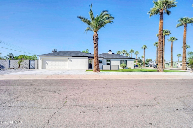 2926 N 16th Ave, Phoenix, AZ 85015 - view of front of property with fence, stucco siding, a garage, and concrete driveway
