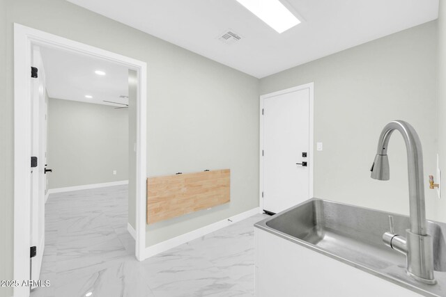 2926 N 16th Ave, Phoenix, AZ 85015 - bathroom with baseboards, visible vents, marble finish floor, and a sink