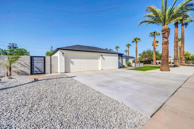 2926 N 16th Ave, Phoenix, AZ 85015 - view of front of property with stucco siding, a gate, driveway, an attached garage, and fence