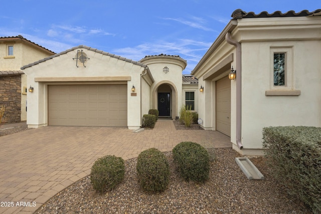 mediterranean / spanish home with a garage