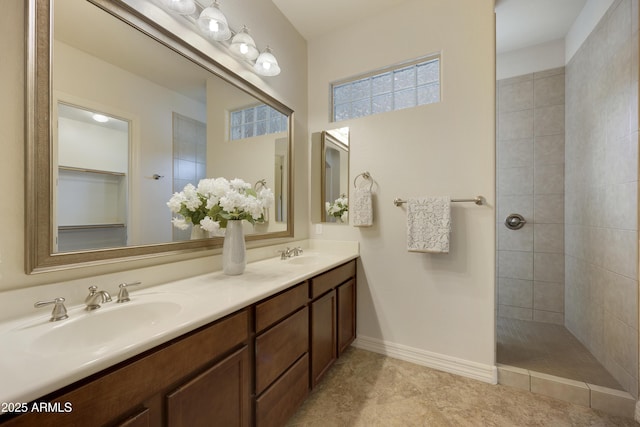 bathroom with vanity and tiled shower