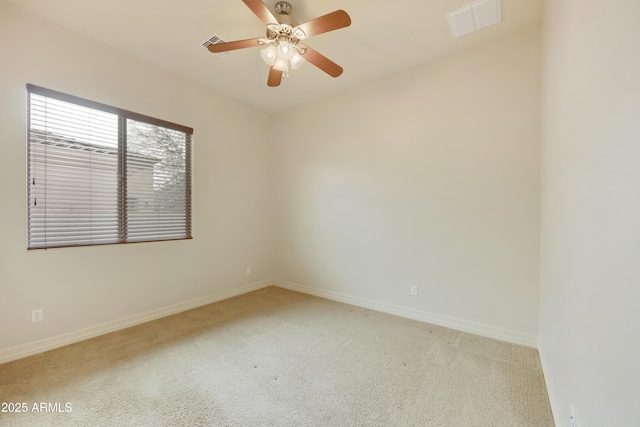 spare room featuring light carpet and ceiling fan