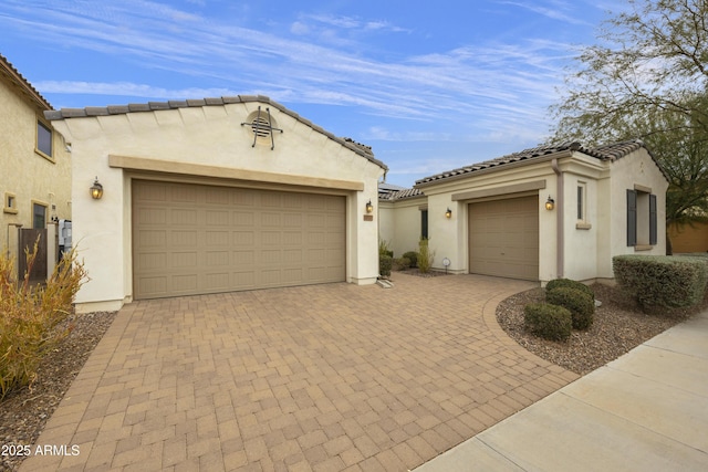 mediterranean / spanish home with a garage