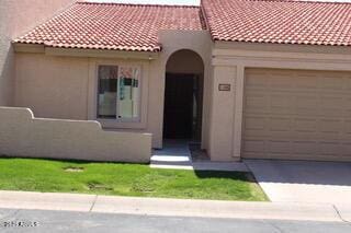 mediterranean / spanish home with concrete driveway, a tiled roof, an attached garage, and stucco siding