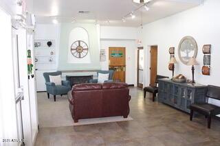 living area with track lighting and a fireplace