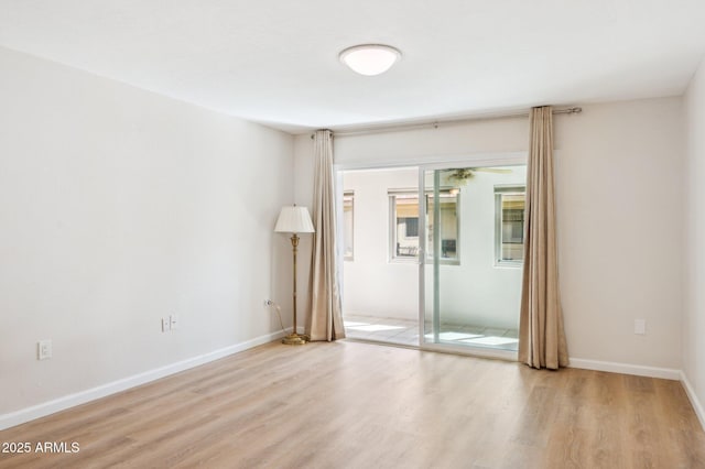 unfurnished room featuring wood finished floors and baseboards