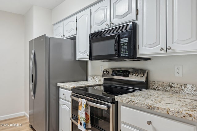 kitchen with white cabinetry, light wood-style flooring, baseboards, and appliances with stainless steel finishes