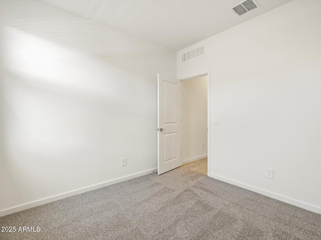 unfurnished room with light carpet, visible vents, and baseboards