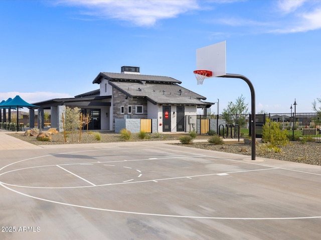 view of basketball court with community basketball court and fence