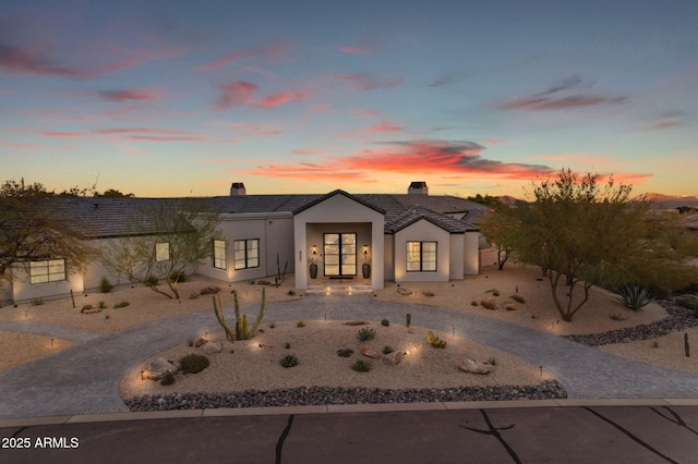 9301 E Via Montoya, Scottsdale, AZ 85255 - view of front of property featuring stucco siding, curved driveway, a chimney, and a tile roof