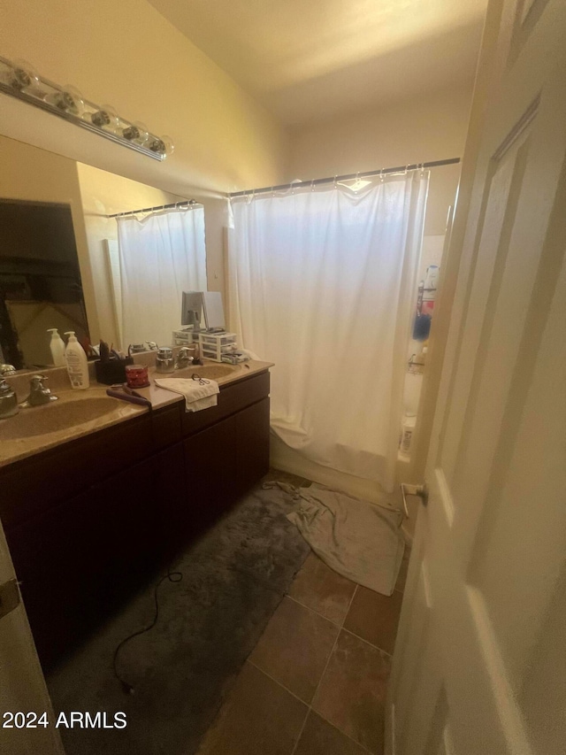 bathroom featuring tile patterned flooring, shower / bath combo, and vanity