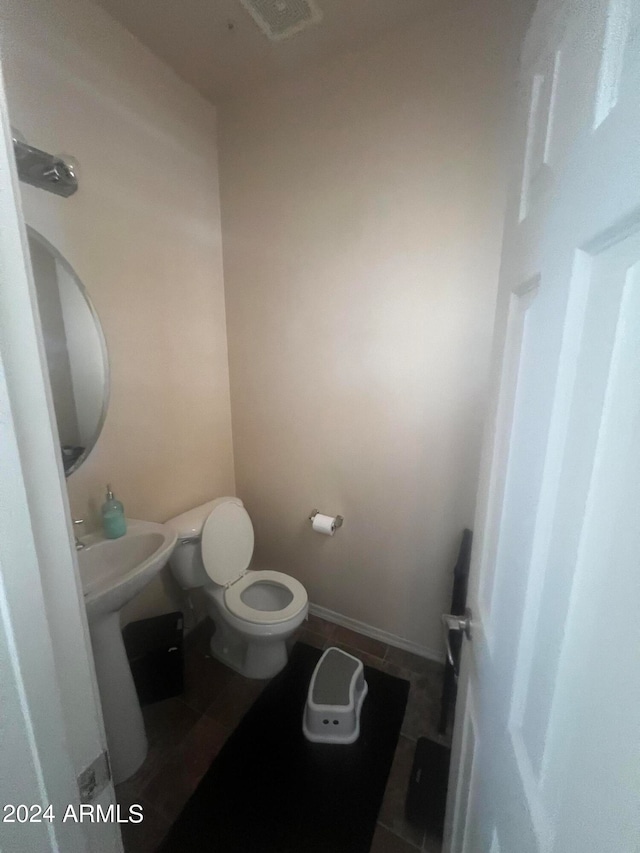 bathroom featuring tile patterned flooring and toilet