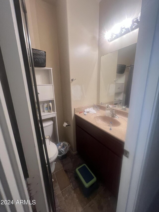 bathroom with vanity, toilet, and tile patterned floors