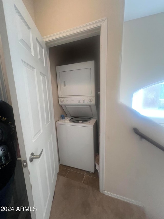 laundry room with carpet floors and stacked washing maching and dryer