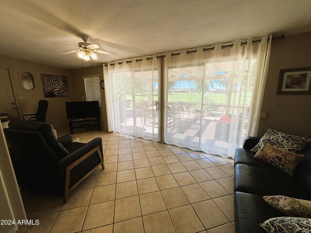 living room featuring light tile patterned floors and ceiling fan