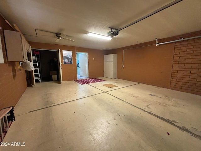 garage with a garage door opener and ceiling fan