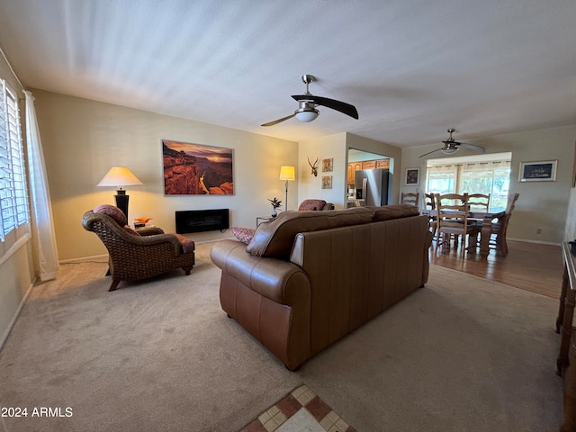 carpeted living room featuring ceiling fan