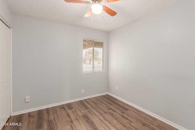 empty room featuring wood-type flooring, a textured ceiling, and ceiling fan