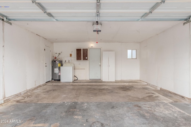 garage featuring washer / clothes dryer, water heater, and a garage door opener