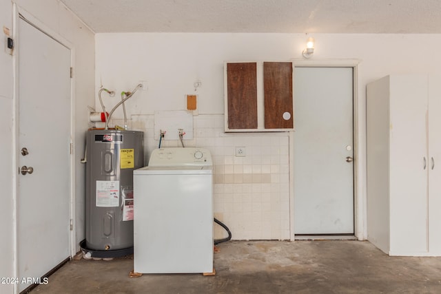 laundry area featuring tile walls, washer / dryer, a textured ceiling, and water heater