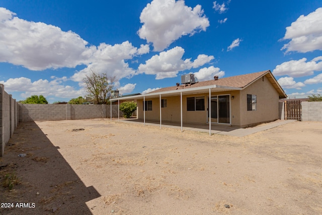 rear view of property featuring cooling unit and a patio area