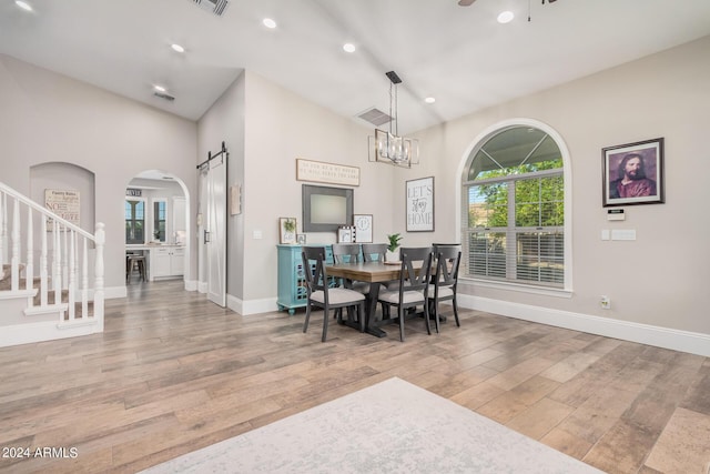 dining room featuring wood finished floors, baseboards, recessed lighting, stairs, and ceiling fan with notable chandelier