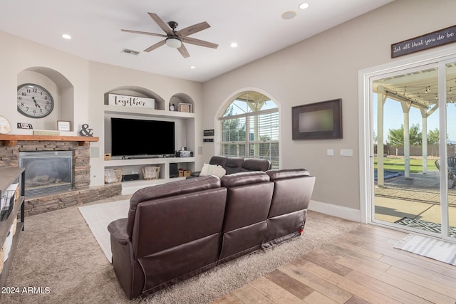 living room featuring recessed lighting, visible vents, wood finished floors, and a fireplace