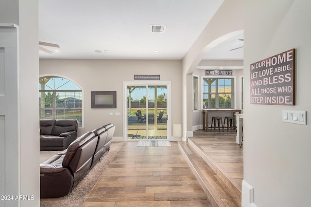 interior space featuring visible vents, baseboards, light wood-type flooring, and ceiling fan