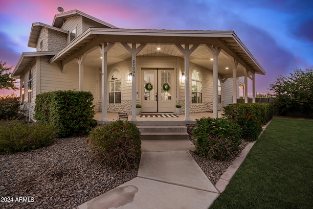 view of front facade with a yard and covered porch