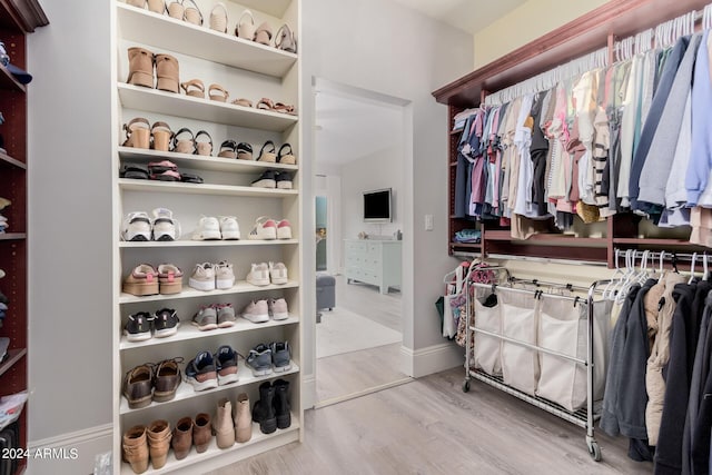 spacious closet with wood finished floors