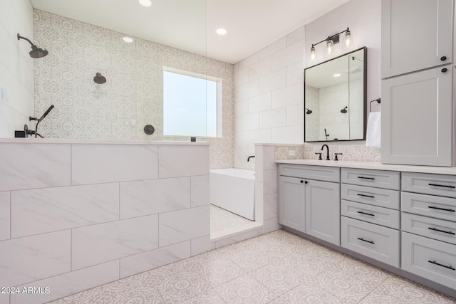 bathroom with tile patterned flooring, a walk in shower, vanity, a bath, and tile walls