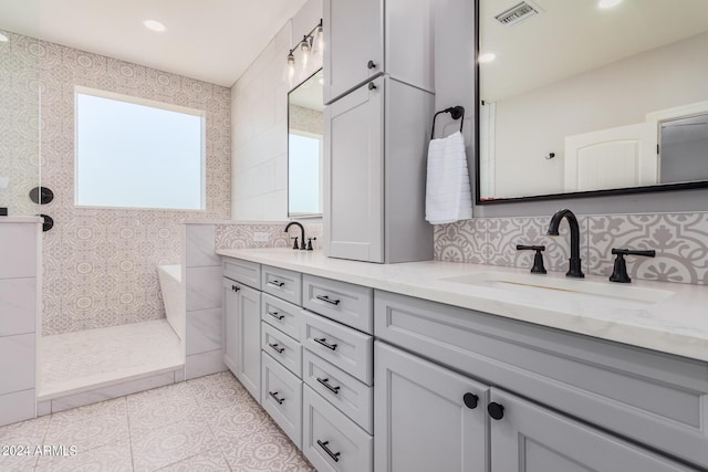 full bath with a sink, visible vents, double vanity, and a walk in shower