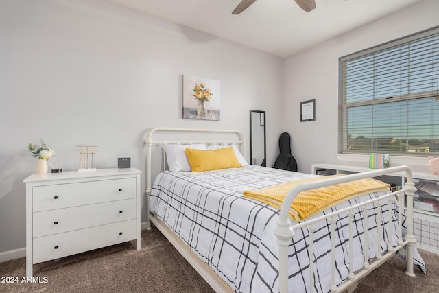 bedroom with dark colored carpet, baseboards, and a ceiling fan