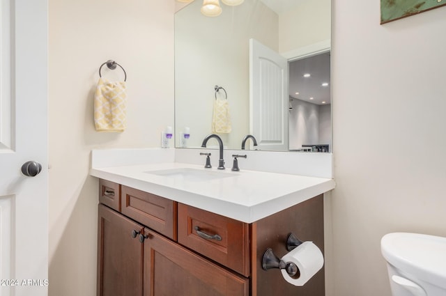 bathroom featuring toilet and vanity