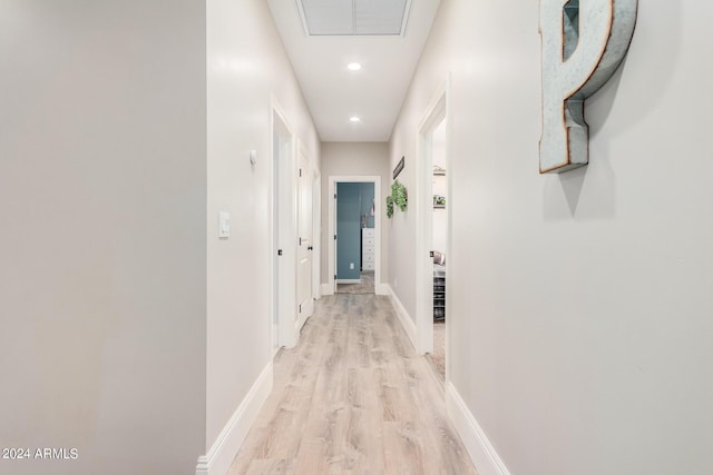 hall with recessed lighting, baseboards, and light wood finished floors