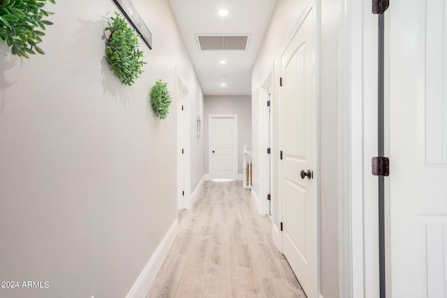 hallway featuring light wood-style floors, recessed lighting, baseboards, and visible vents