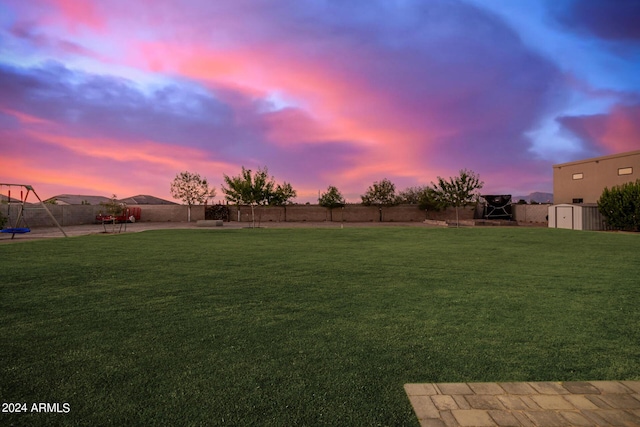 yard at dusk with a fenced backyard