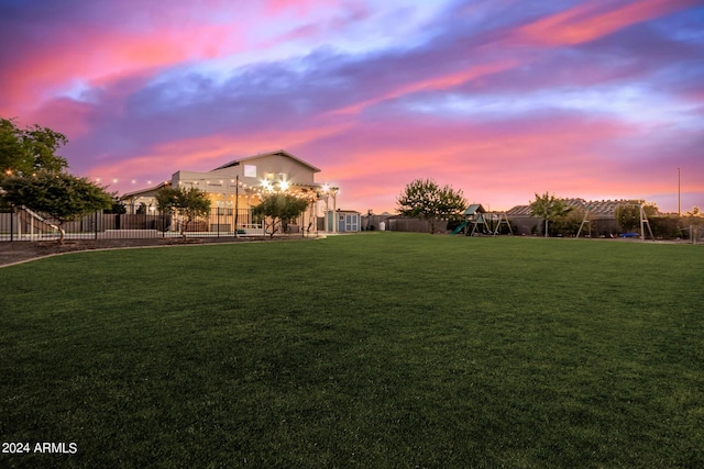 view of yard with a pergola, playground community, and fence