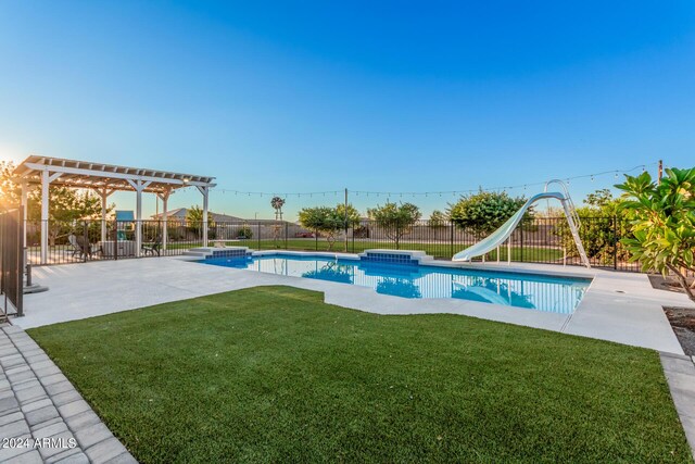 view of swimming pool with a lawn, a water slide, a fenced backyard, and a pergola