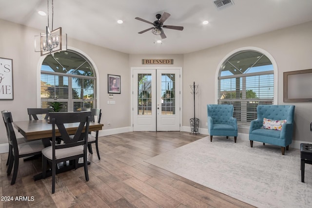 dining area with wood finished floors, visible vents, baseboards, recessed lighting, and french doors