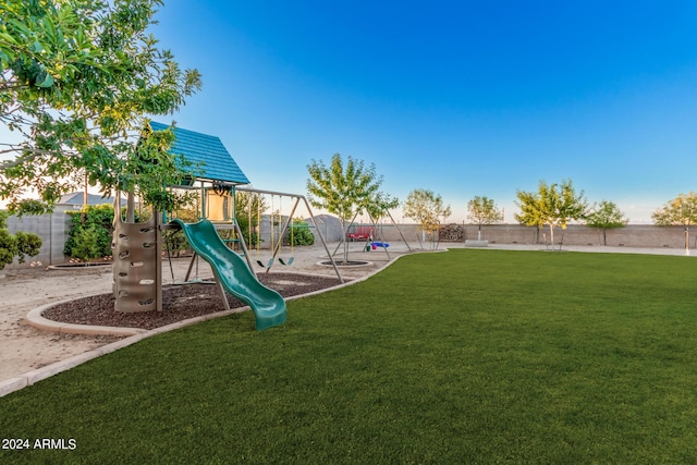 communal playground with a yard and fence