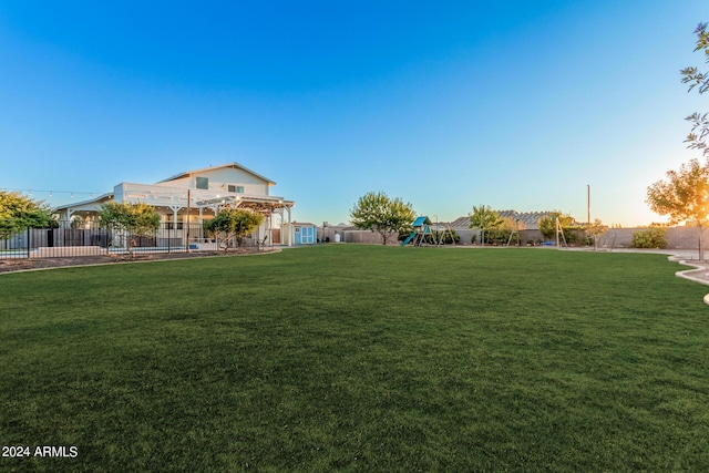 view of yard with fence and playground community