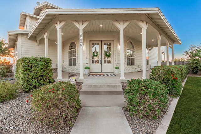 property entrance with french doors and covered porch