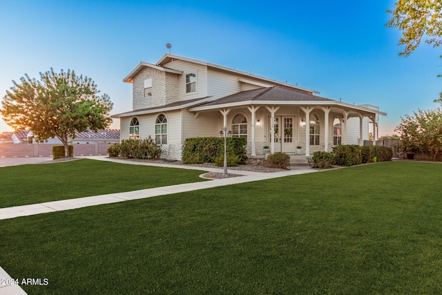 view of front of property featuring a porch, a front yard, and fence