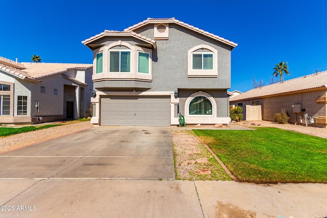 mediterranean / spanish house with a garage, concrete driveway, stucco siding, a tiled roof, and a front yard